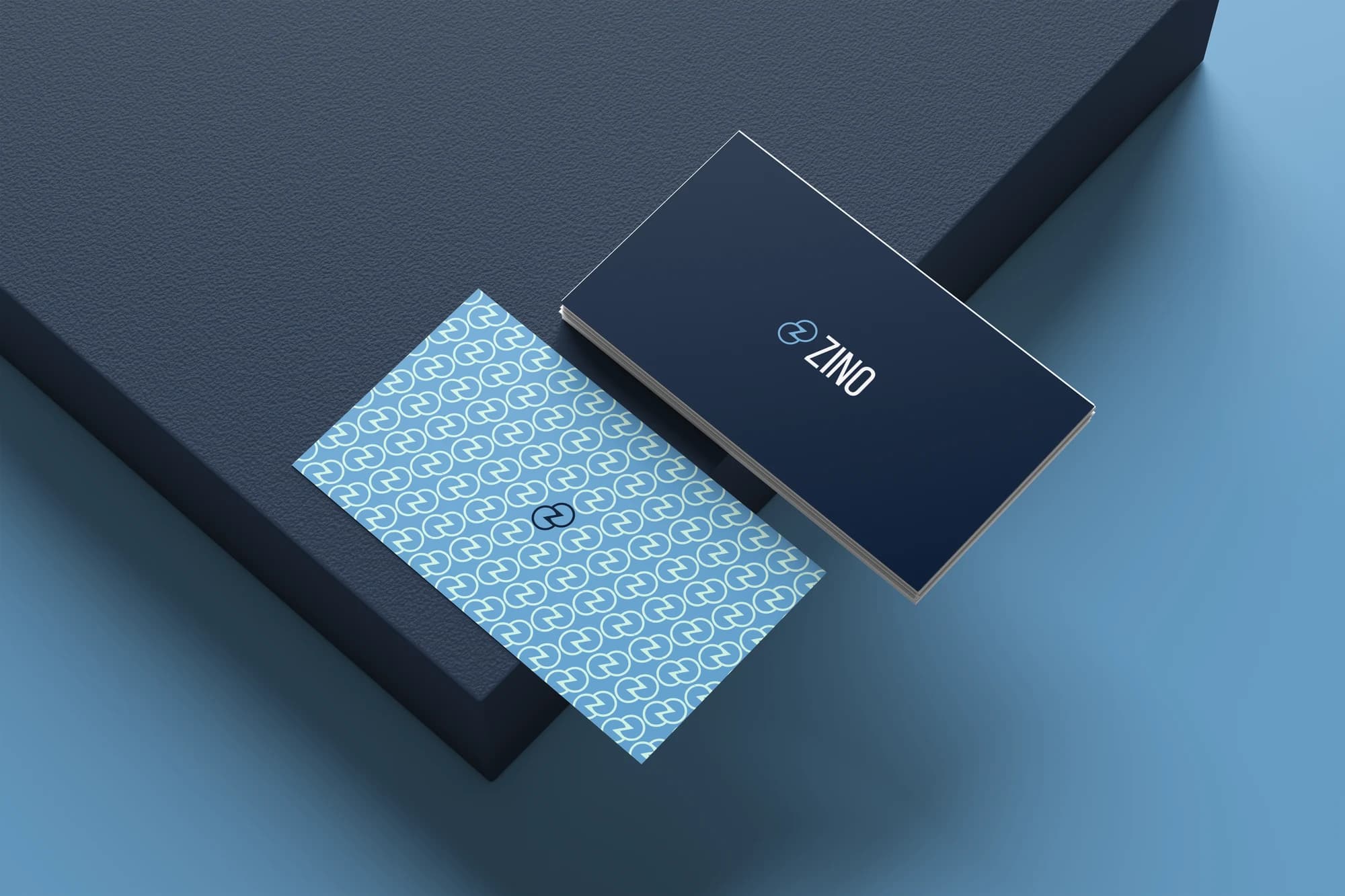 ZINO navy and pale blue business cards with the brand pattern